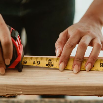 b10 Female carpenter measuring the lumber - Image by © rawpixel